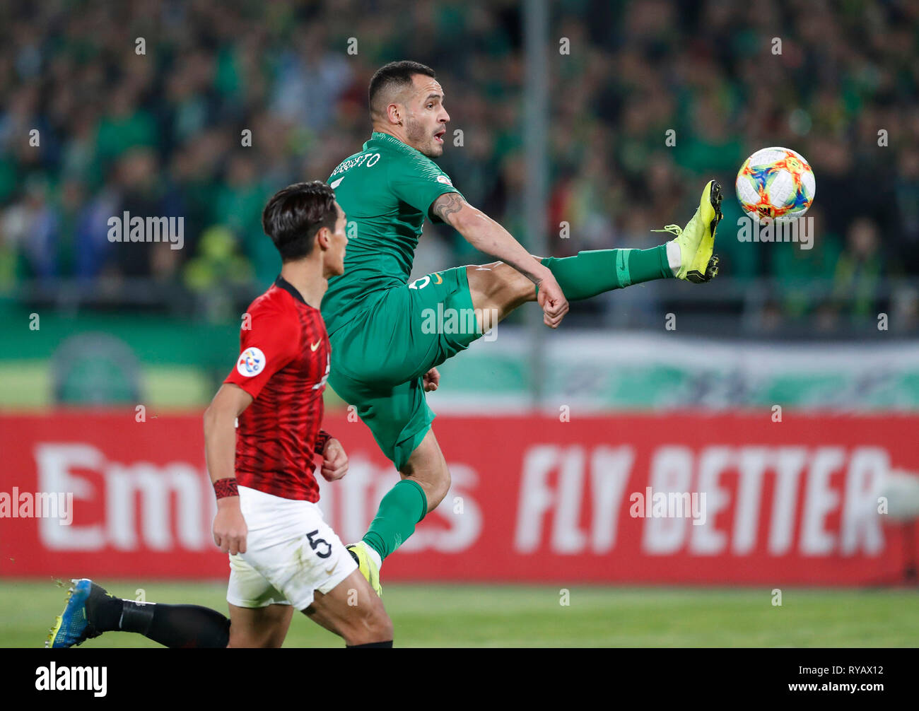 Beijing, China. 13th Mar, 2019. Beijing Guoan's Renato Augusto (R) competes during the group G match between Beijing Guoan FC and Urawa Red Diamonds at the 2019 AFC Champions League in Beijing, capital of China, March 13, 2019. The match ended in a 0-0 draw. Credit: Ding Xu/Xinhua/Alamy Live News Stock Photo