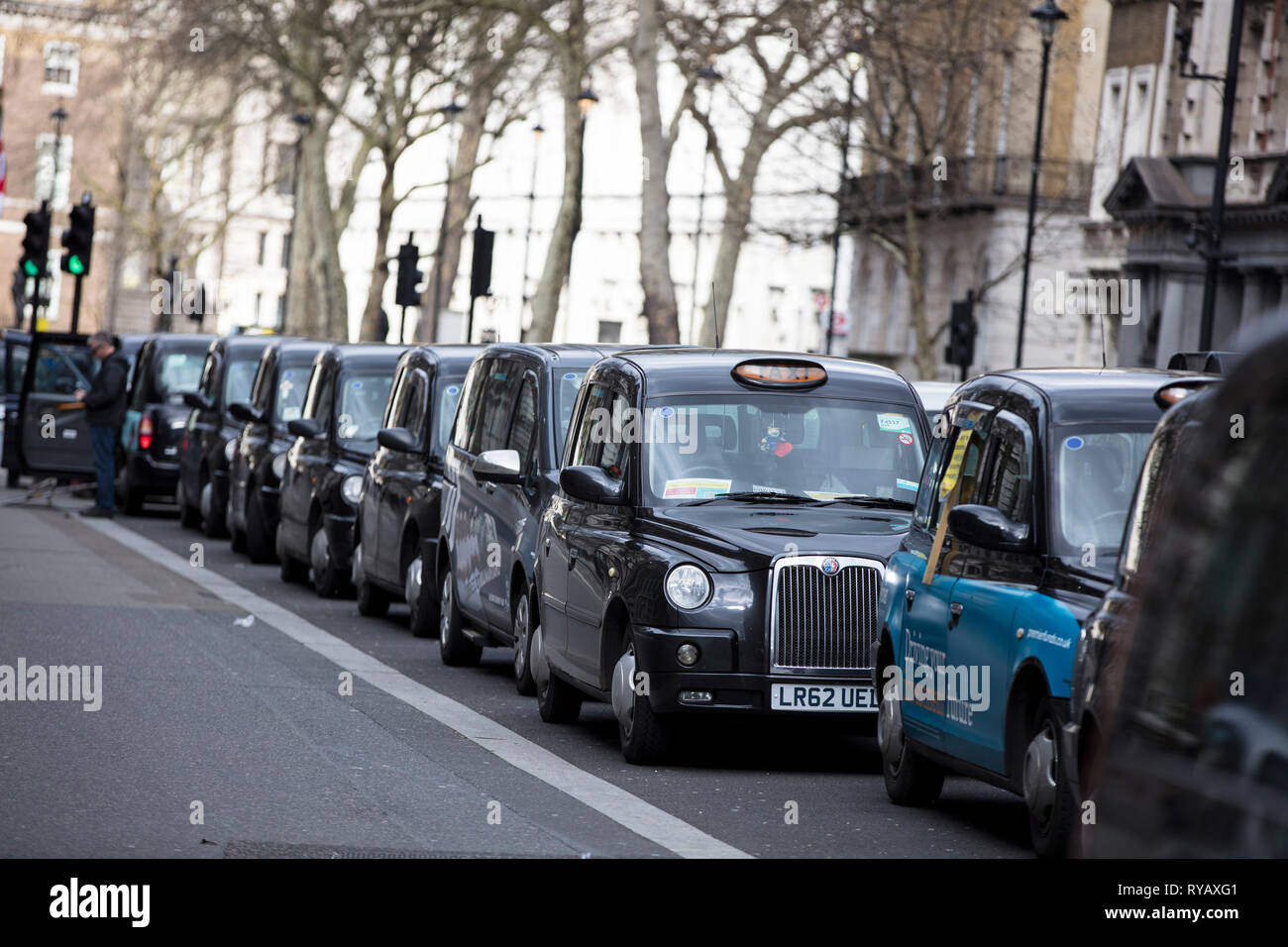 LONDON, UK - March 13th 2019: Black cabs block roads around Westminster in protest over plans to ban them driving on roads in parts of London Credit: Ink Drop/Alamy Live News Stock Photo