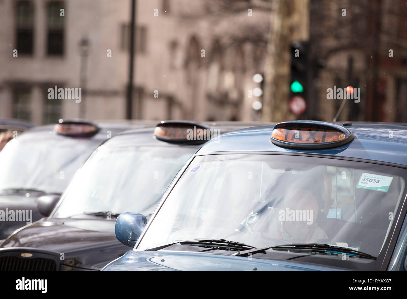 LONDON, UK - March 13th 2019: Black cabs block roads around Westminster in protest over plans to ban them driving on roads in parts of London Credit: Ink Drop/Alamy Live News Stock Photo