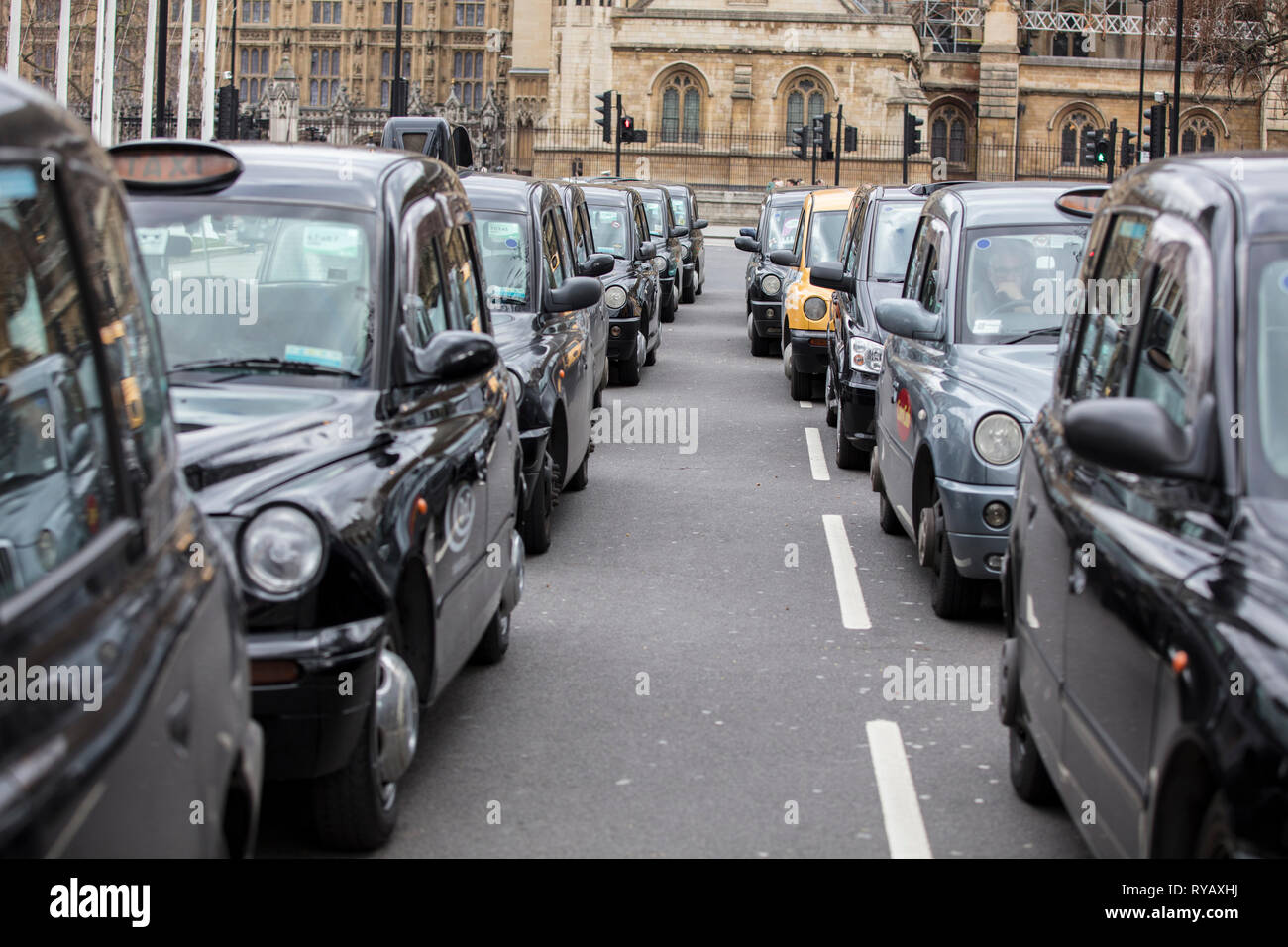 LONDON, UK - March 13th 2019: Black cabs block roads around Westminster in protest over plans to ban them driving on roads in parts of London Credit: Ink Drop/Alamy Live News Stock Photo