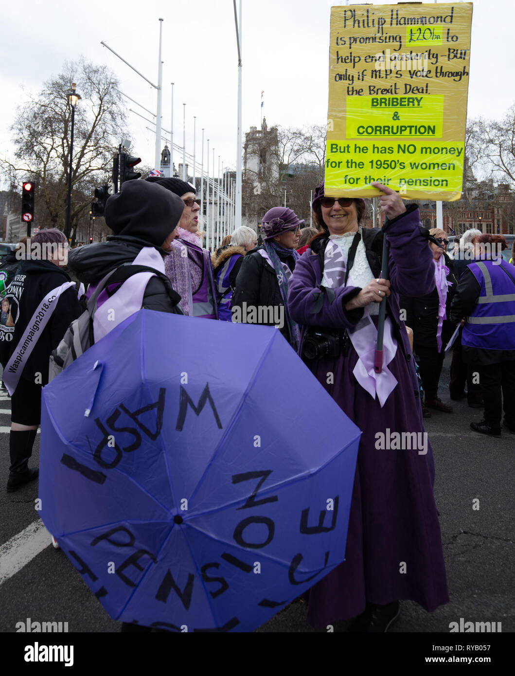 London, UK. 13th March 2019. Group of protesters of Solent WASPI (Women Against State Pension Inequality) campaign against unfair changes to State Pension Age imposed on women born in the 1950s near the Houses of Parliament, London, UK, today. Credit: Joe Kuis / Alamy Live News Stock Photo