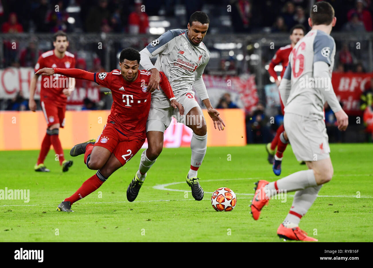 Munich, Germany. 13th Mar, 2019. Soccer: Champions League, knockout round, round of sixteen, second leg: FC Bayern Munich - FC Liverpool in the Allianz Arena. Munich's Serge Gnabry (l) and Liverpool's Joel Matip fight for the ball. Credit: Peter Kneffel/dpa/Alamy Live News Stock Photo
