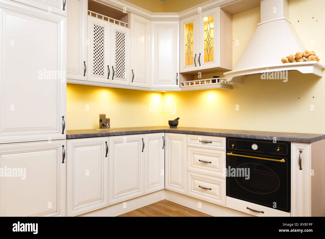 White empty kitchen with light white furniture - Warm lights and nicely ...