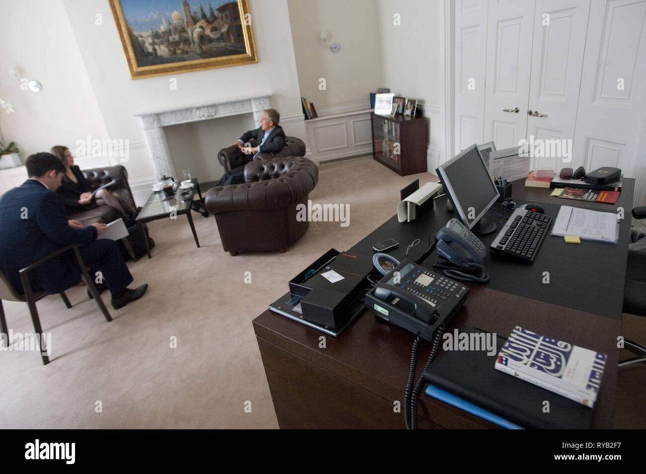 copy of the Koran / Qur'an on his desk.     Former British PM Tony Blair pictured in his  ' home office ' , 9 Grosvenor Square , London W1.      In between copious quantities of coffee the former PM was principally discussing his role in the Middle East Peace process as the Quartet Middle East Peace Envoy . Also commented on the Arab Spring, the crucial need to keep Iran's nuclear ambitions in check and the Pope's first tweet . The PM emphasised  the compatibility of world religion with global peace and prosperity and the wisdom he found both in the bible and  the Qur' an that he claimed to re Stock Photo