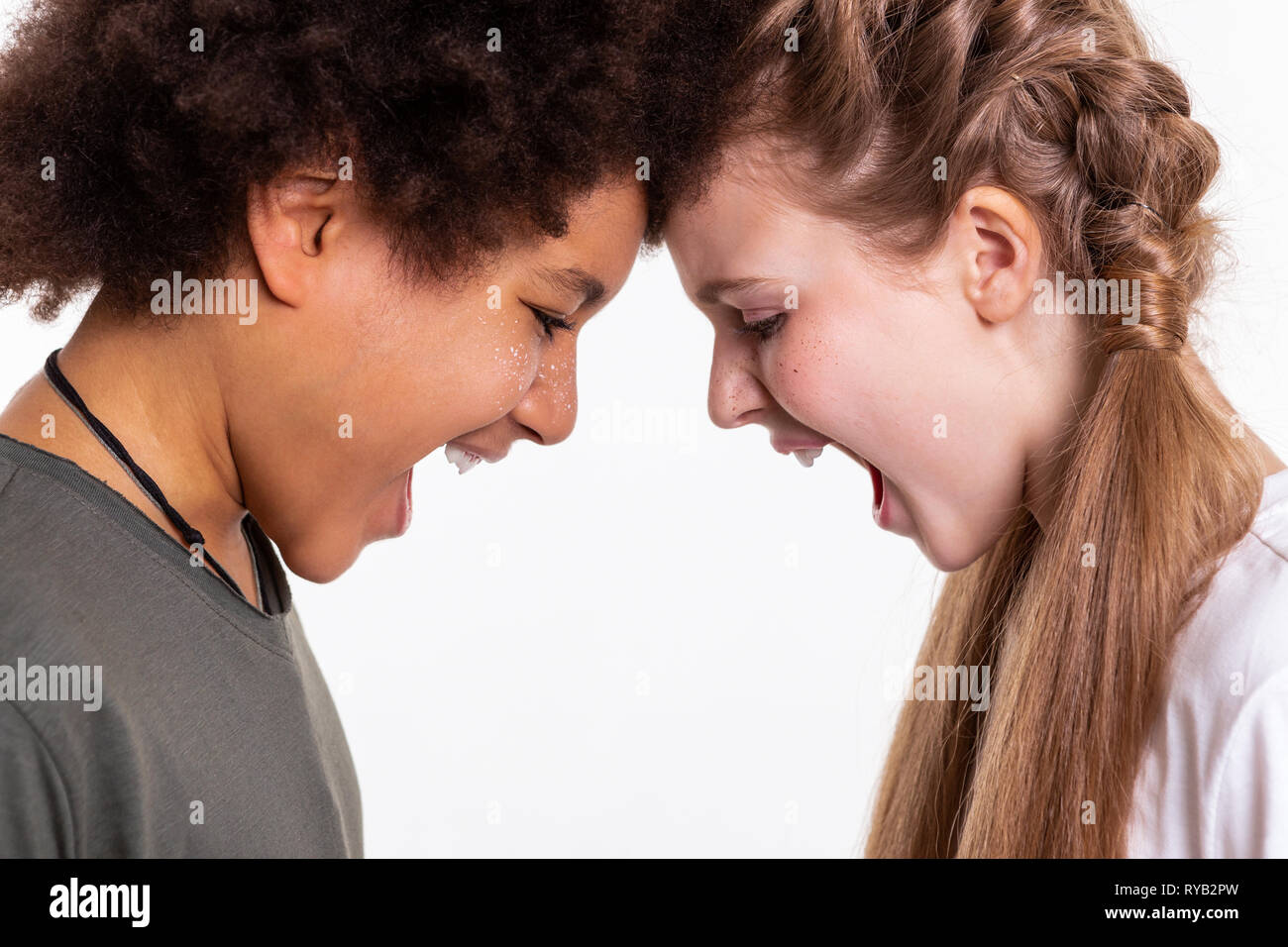 Emotional and expressive kids leaning on each other Stock Photo