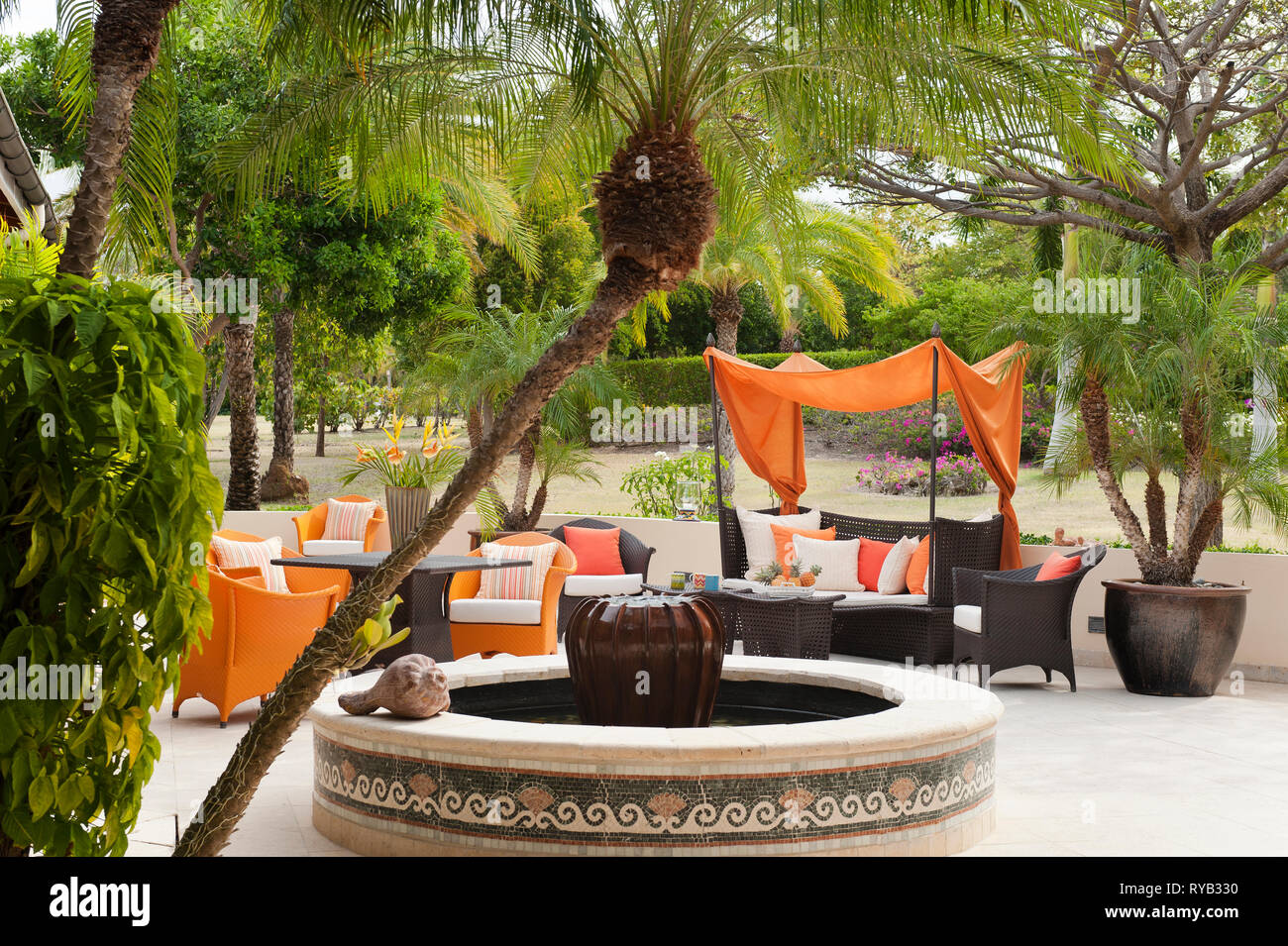 "Fountain by furniture on patio at Tamarind Cove, Antigua Stock Photo