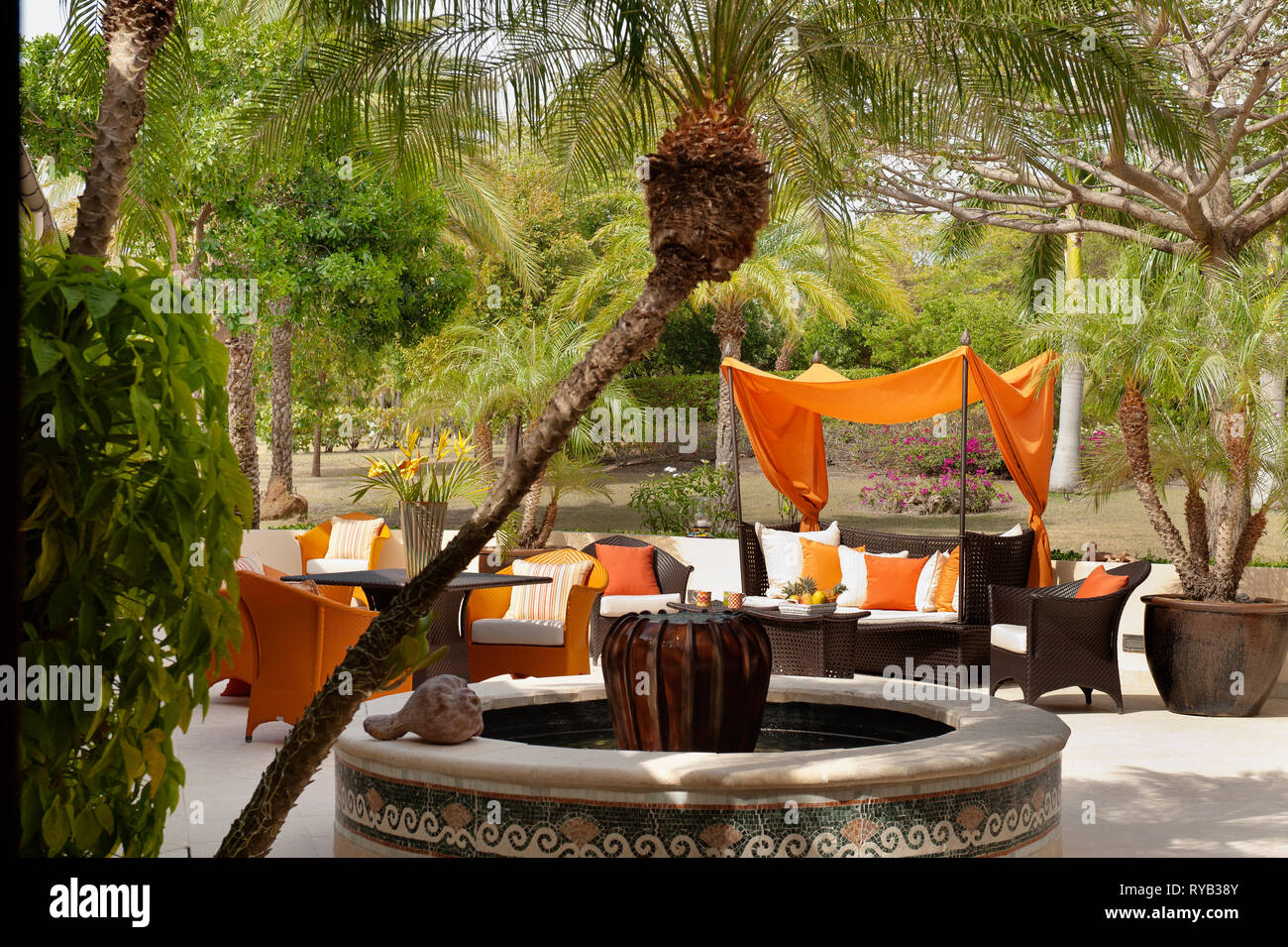 "Fountain by furniture on patio at Tamarind Cove, Antigua Stock Photo
