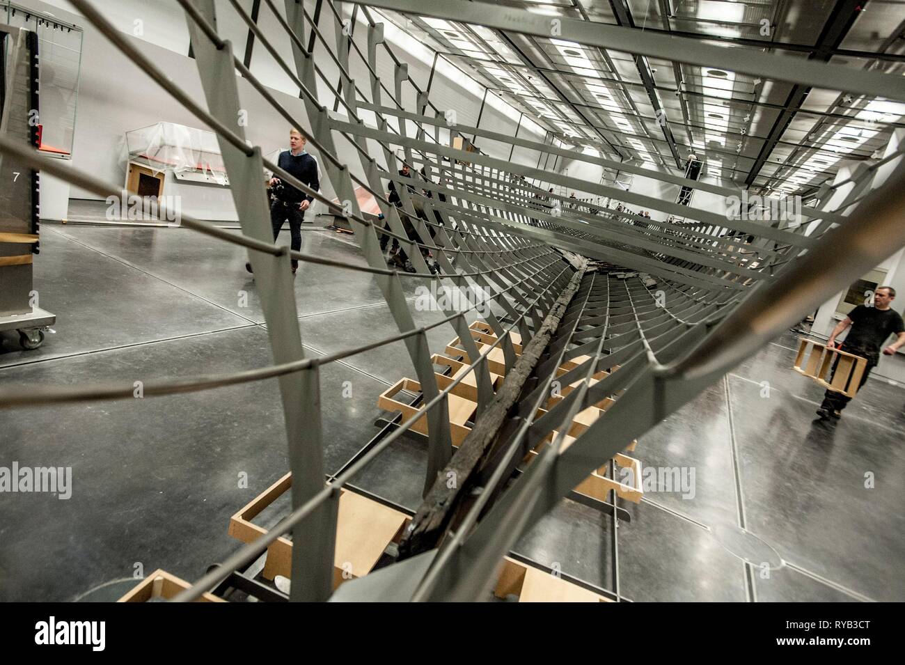 Views of surviving timbers from longest Viking warship ever found displayed in the UK for the first time. The timbers have been painstakingly fitted together like a huge jigsaw and placed inside an actual size steel cradle . The reconstruction work is by members National Museum of Denmark who have come over to the Museum especially.     The 37 metre long ship will form the centrepiece of the British Museum's BP exhibition, Vikings: life and legend.  The ship, known as Roskilde 6, was excavated from the banks of Roskilde fjord in Denmark during the course of work undertaken to develop the Roski Stock Photo