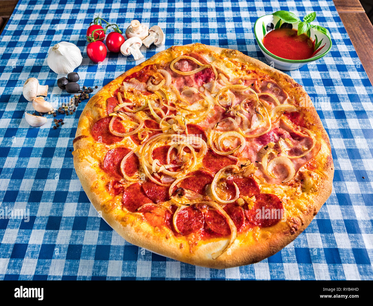Salami and ham pizza with cheese and onion Stock Photo Alamy