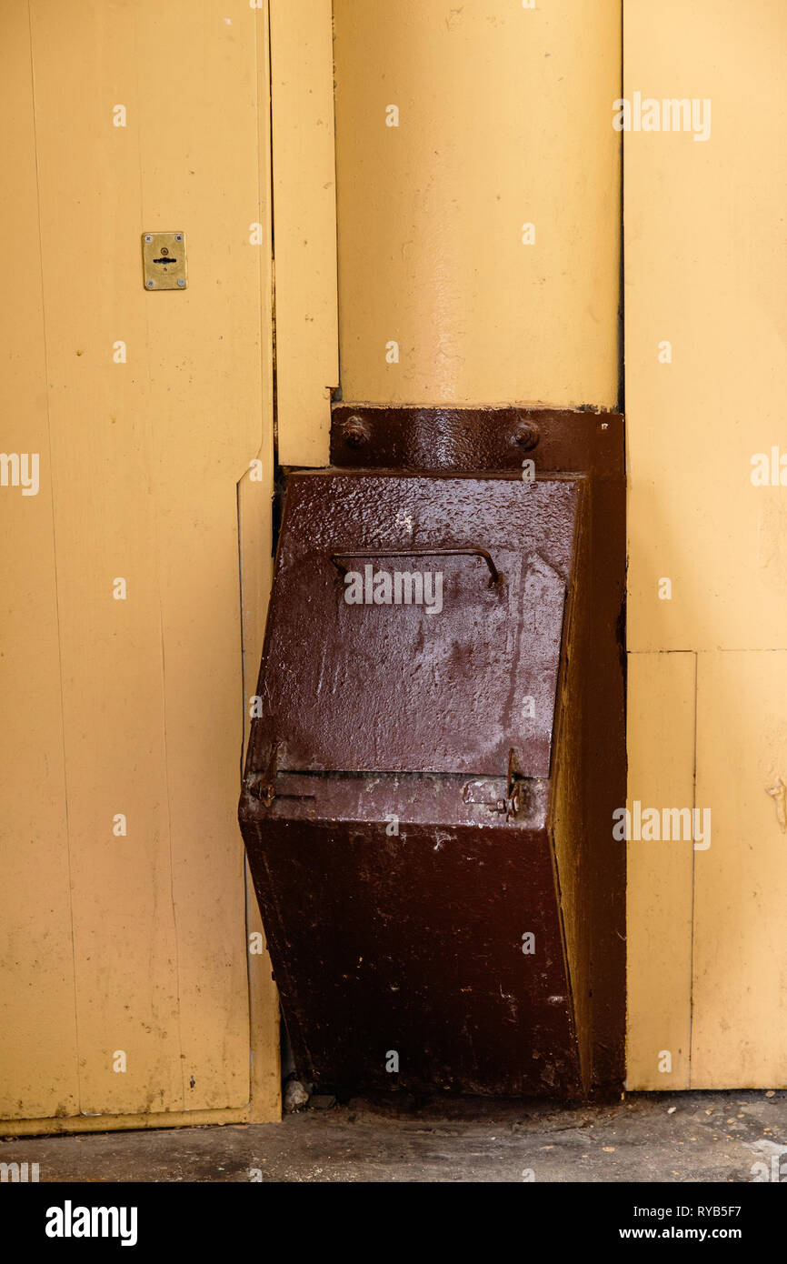 Old garbage chute in apartment building with cheap apartments Rubbish