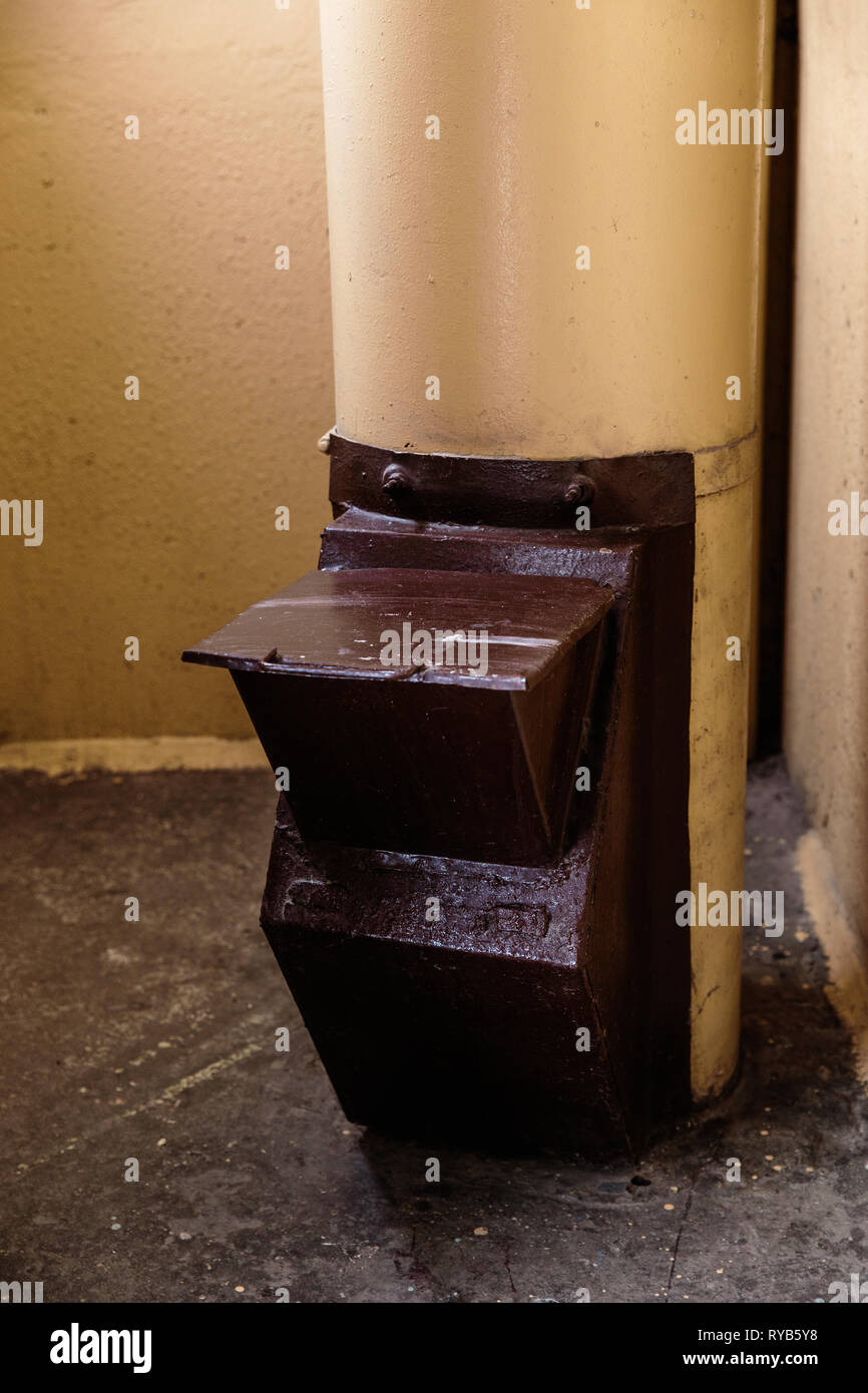 Old garbage chute in apartment building with cheap apartments Rubbish chute in a Soviet block