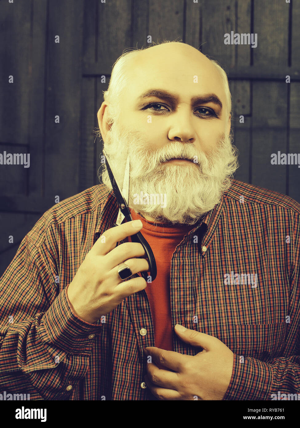 old man cutting beard with scissors Stock Photo Alamy