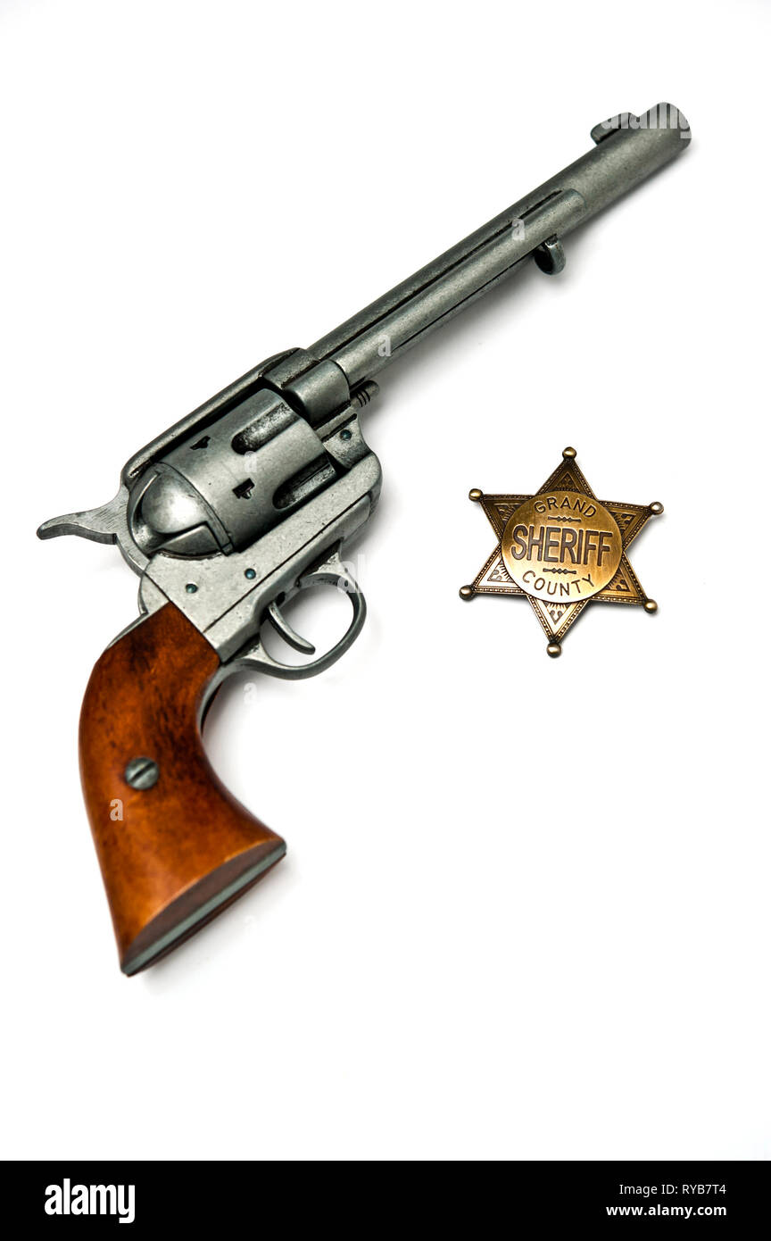 Colt.45 single action gun and sheriff badge Stock Photo