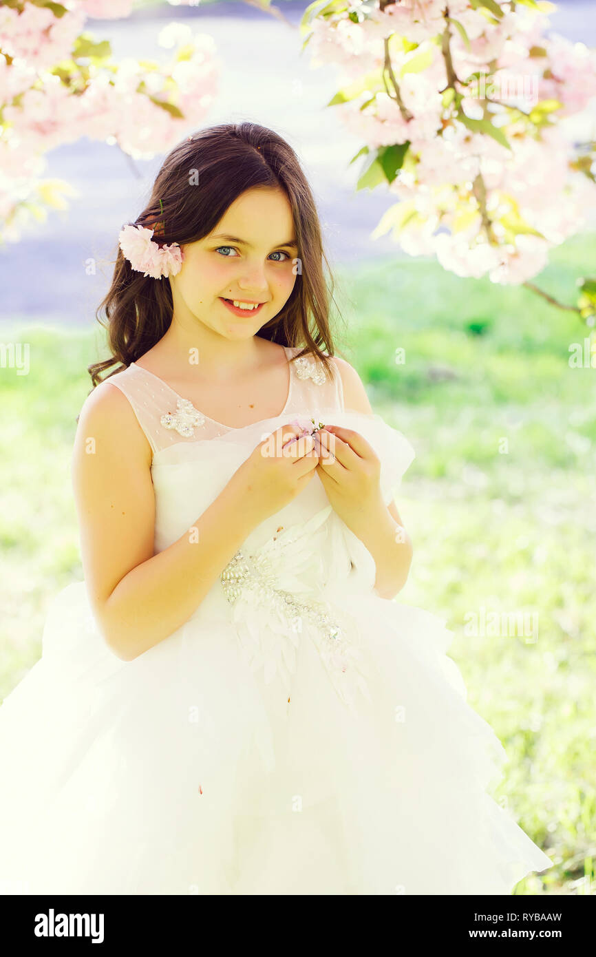 Small smiling girl in blossom Stock Photo - Alamy