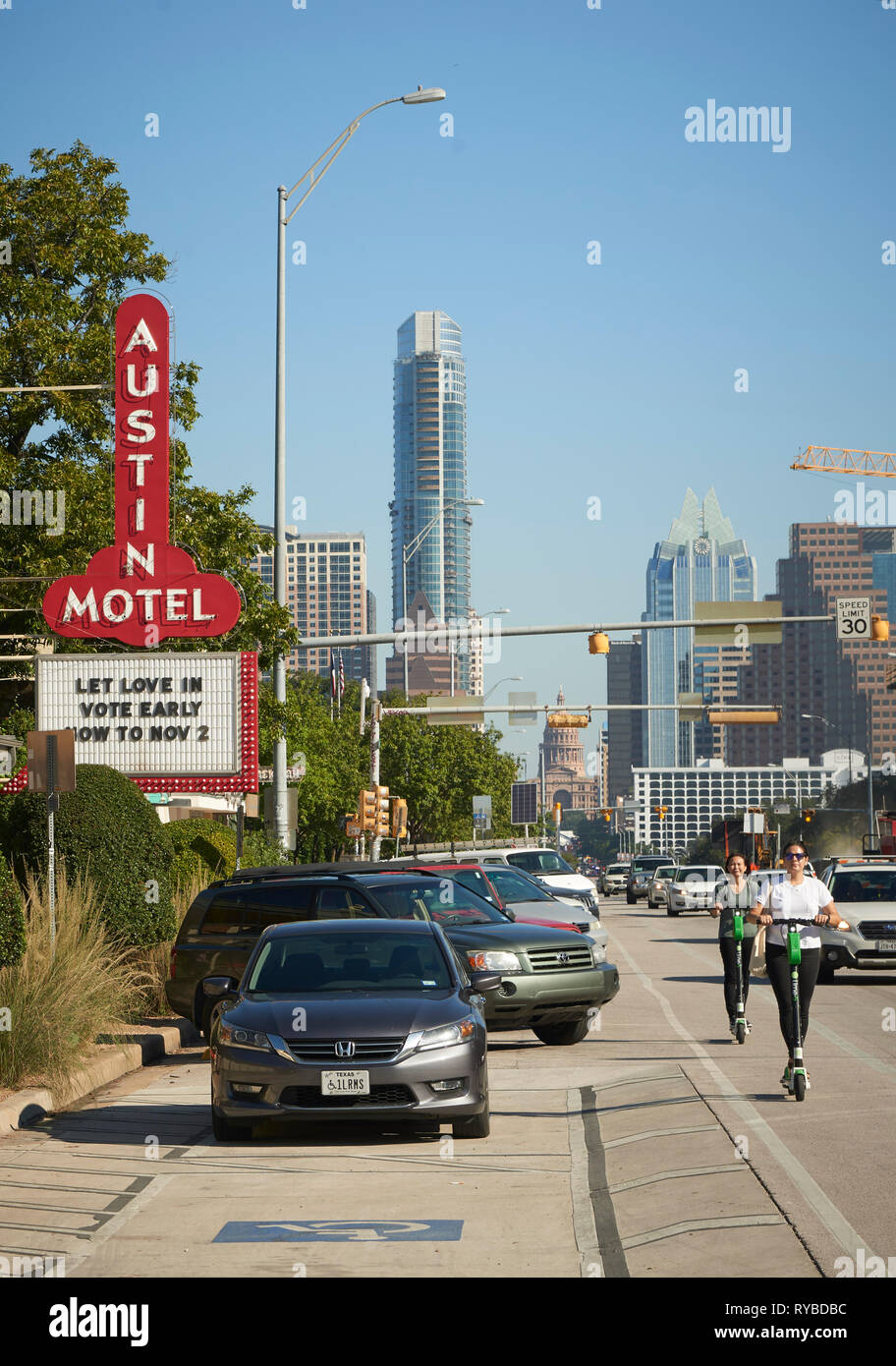 Women riding Electric E Scooters for hire, South Congress Avenue