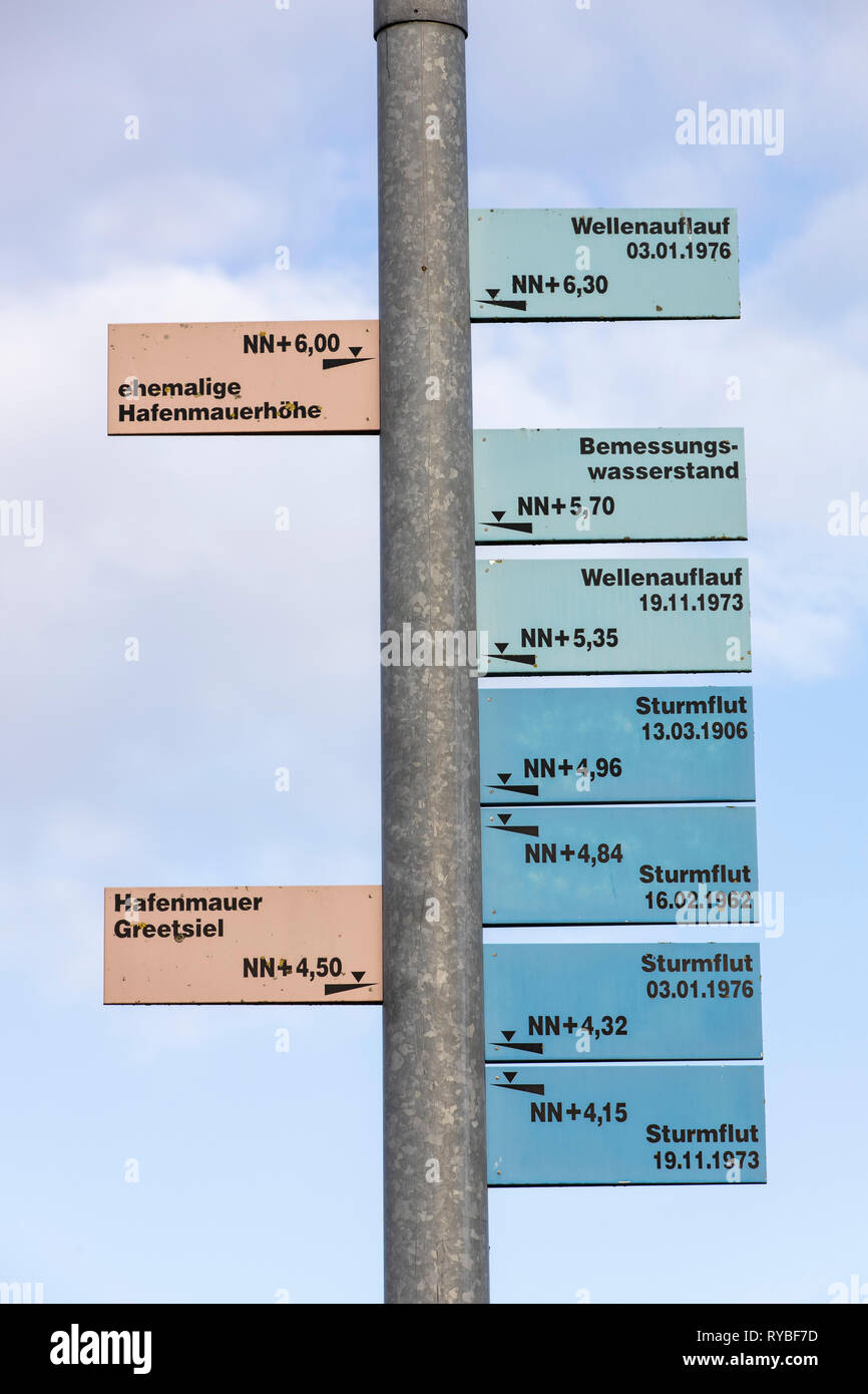 Sign shows the hight of extrem floods during storms,  in the fishing port of Greetsiel, Ostfriesland, Lower Saxony, Stock Photo