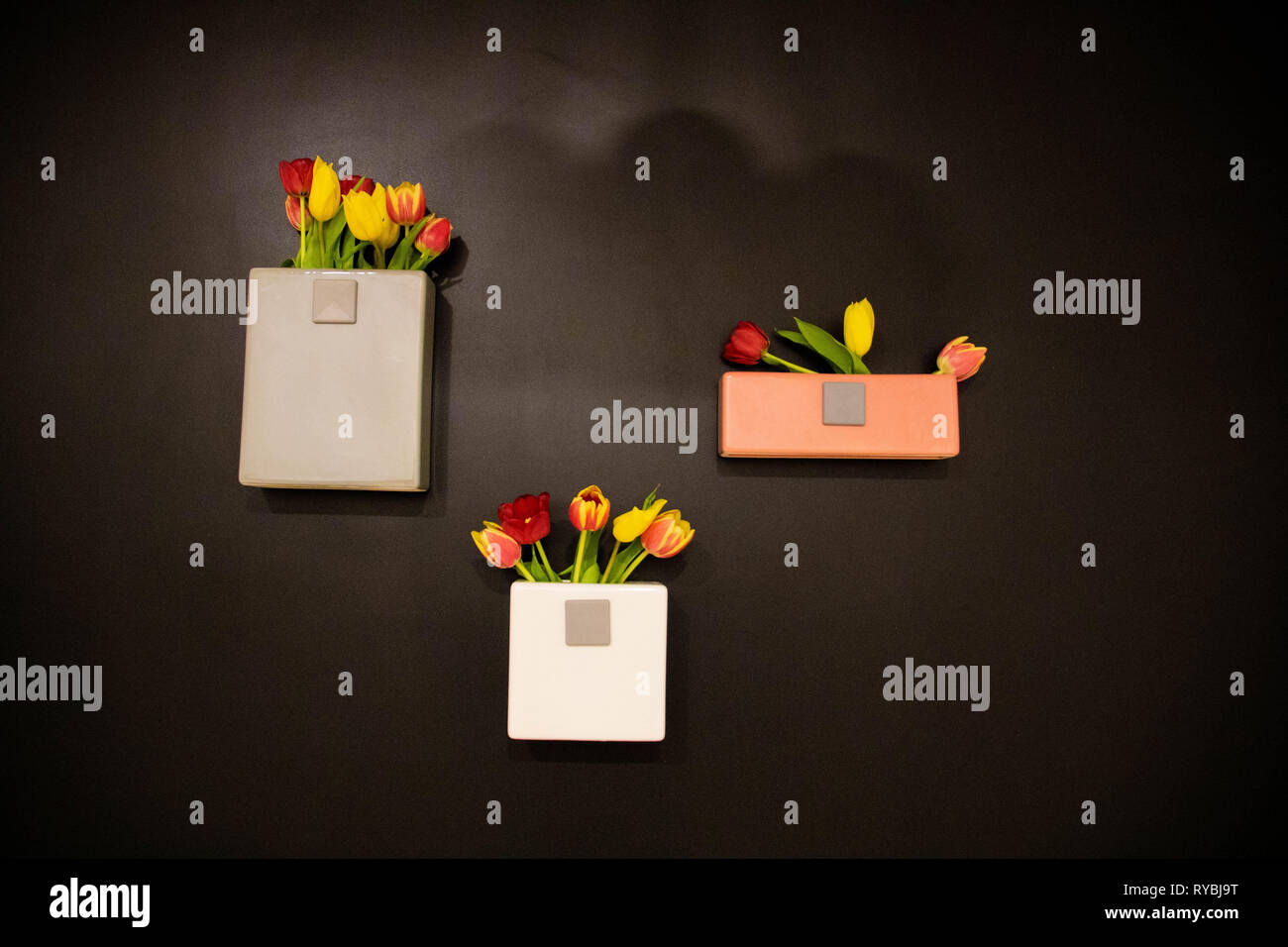 Three vases on black wall Stock Photo