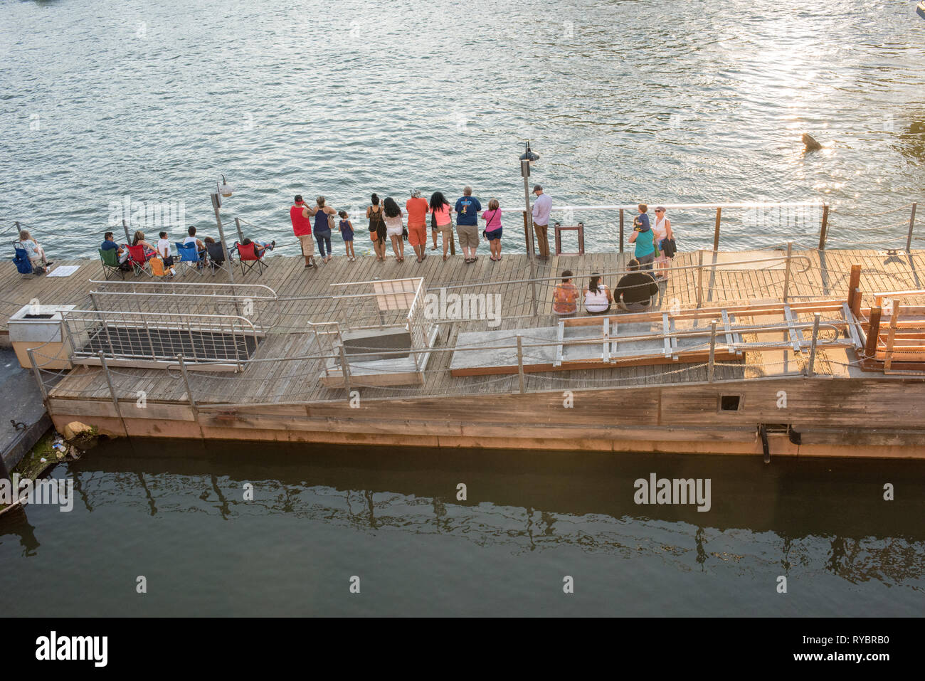 People gather at sunset on a warm summer day in historic Old Sacramento, California, USA Stock Photo