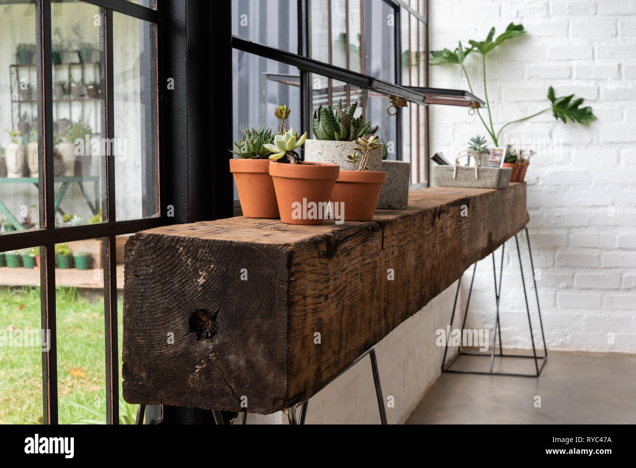 A rustic shelf or counter made from a heavy beam of old wood Stock