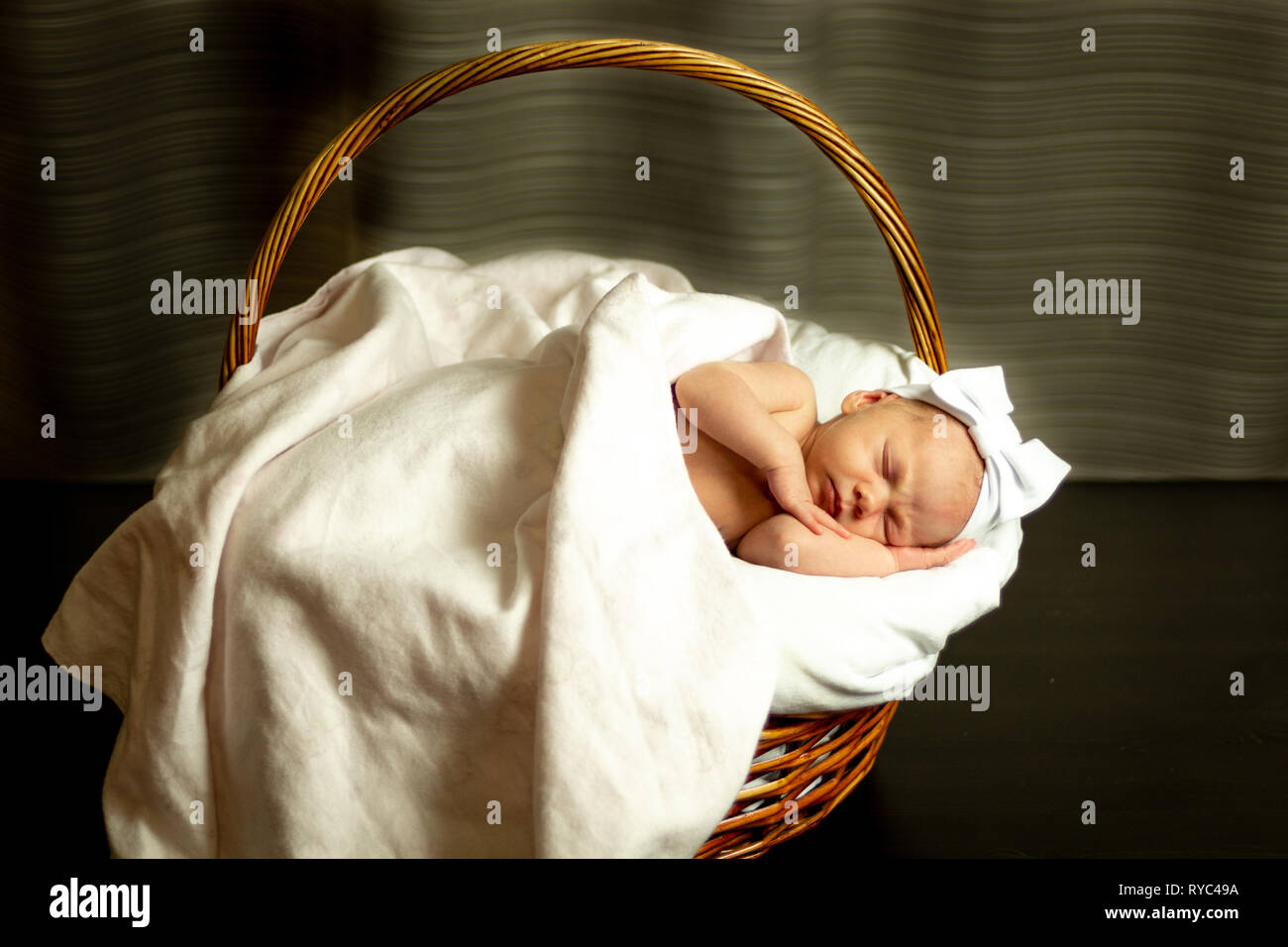 Newborn baby girl sleeping in basket Stock Photo Alamy