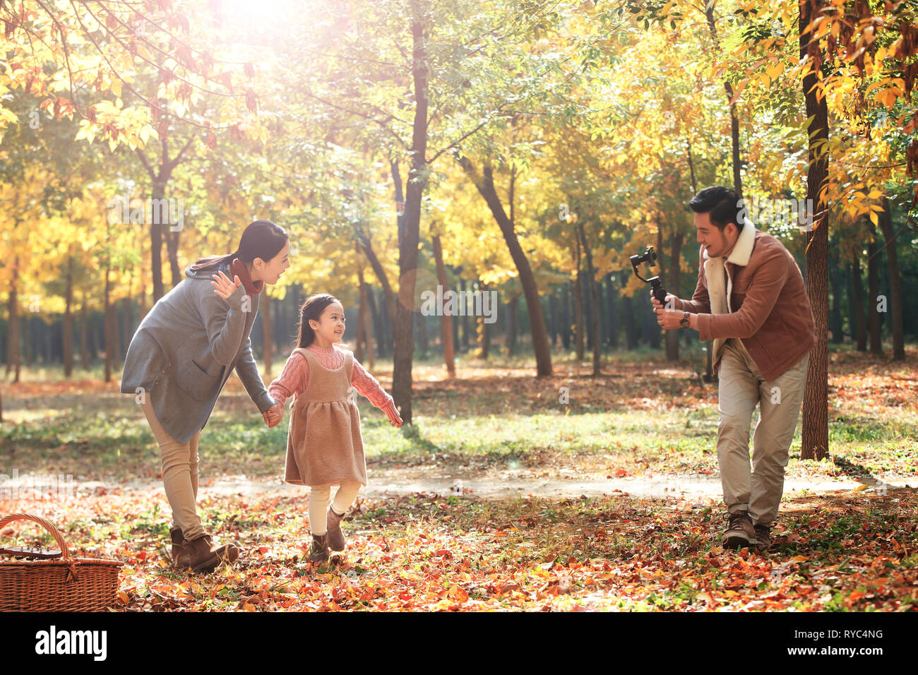 Happy family in the outdoor taking pictures Stock Photo - Alamy
