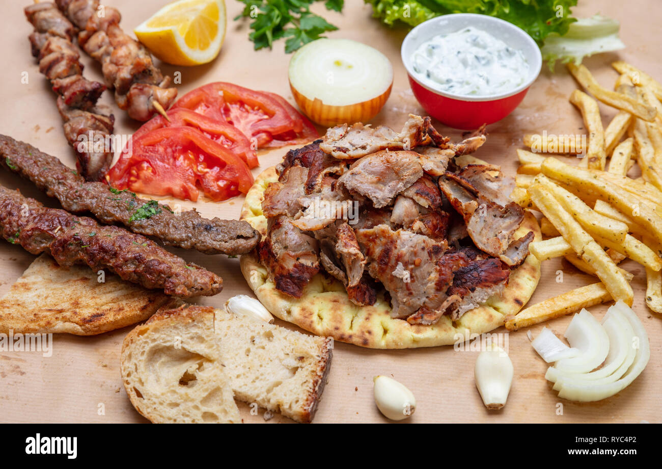 Shawarma, gyros, kebab, souvlaki on pita bread, vegetables and ...