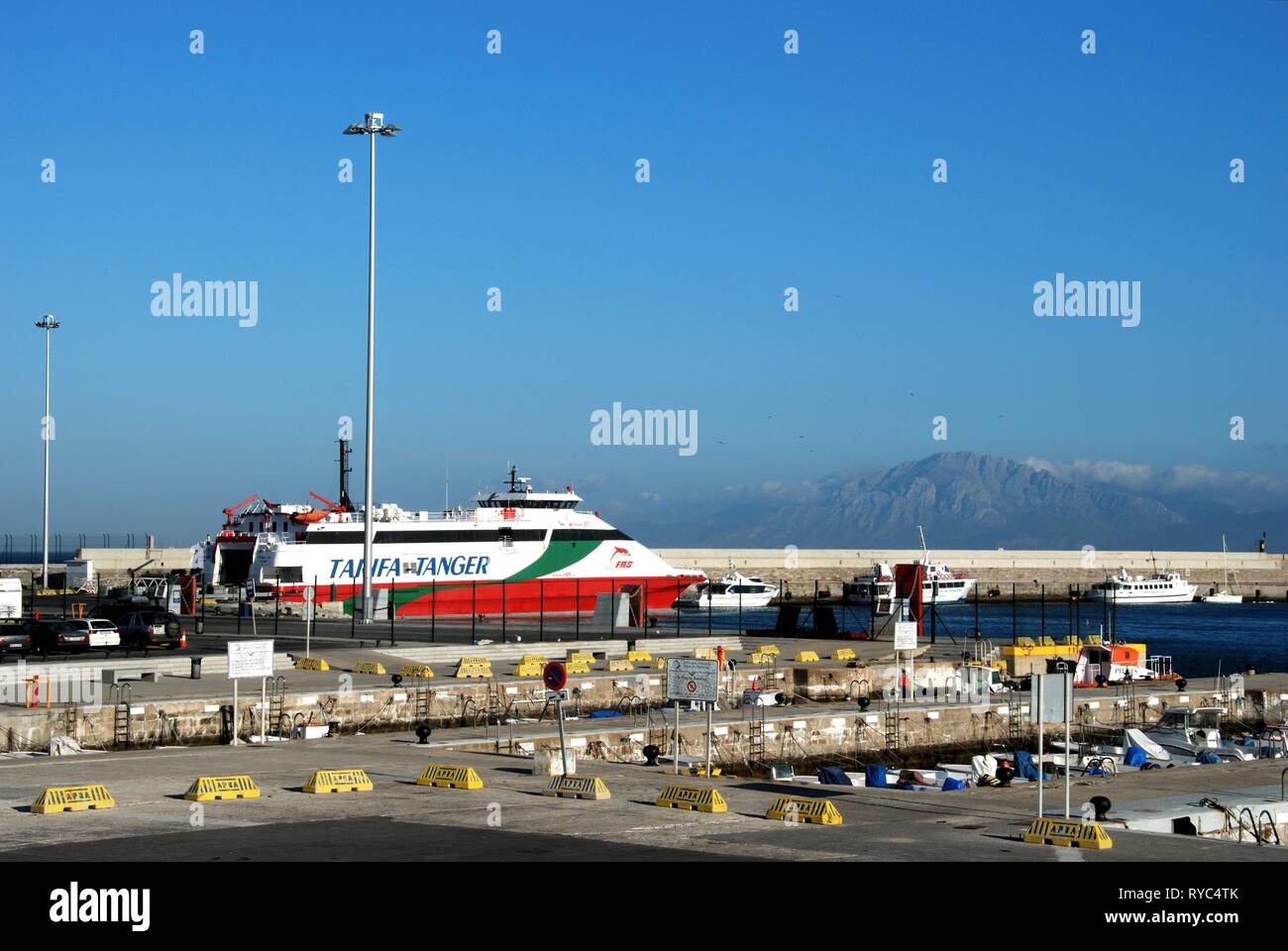 View of Tarifa to Tangier ferry in the harbour with views towards the Moroccan coastline and mountains, Tarifa, Spain. Stock Photo