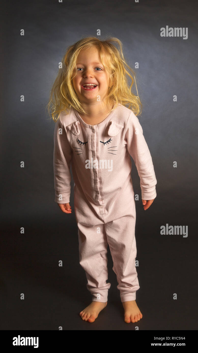 A happy little blond girl just before bedtime Stock Photo