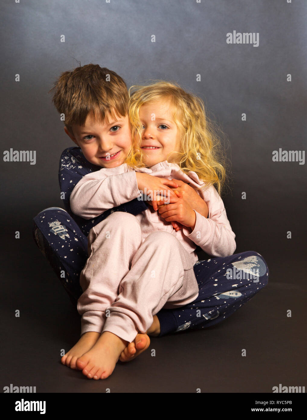 a brother and sister portrait at bedtime Stock Photo