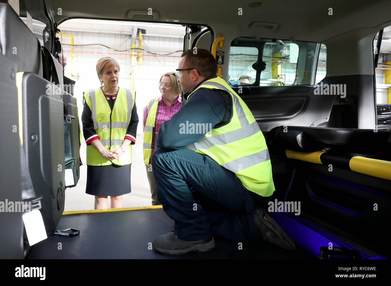 First Minister Nicola Sturgeon with general manager of production and engineering Angela Horn (centre) and team leader Chris Beard (right) during a visit to Allied Vehicles Ltd in Glasgow where cars are converted and modified to make them wheelchair accessible. Stock Photo
