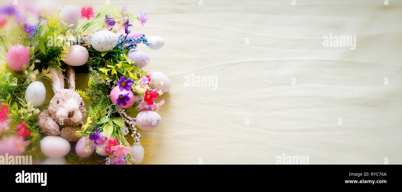 a colorful easter bunny wreath with colored eggs and flowers and pastel ...