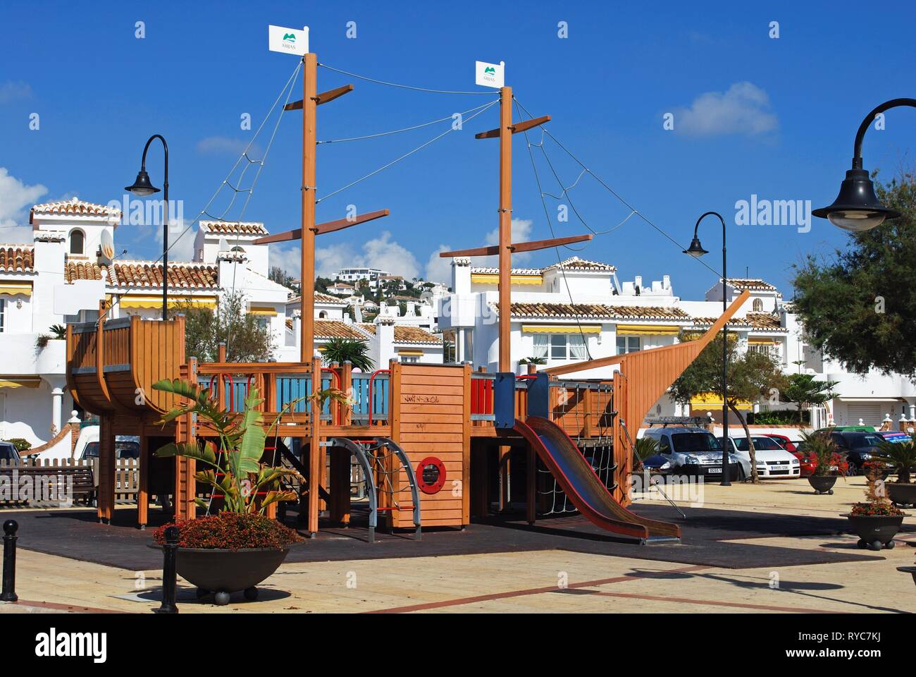 Pirate ship with a slide in the childrens playground along the Paseo Maritimo, La Cala de Mijas, Malaga Province, Andalusia, Spain, Western Europe. Stock Photo