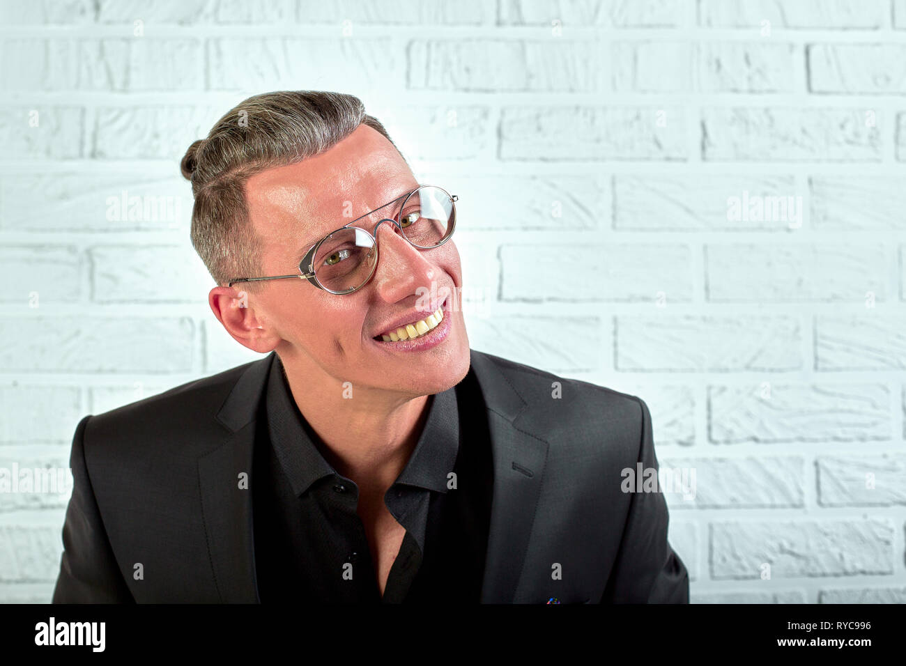 Closeup portrait of a happy young businessman with glasses looking at ...