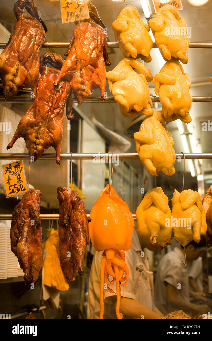 Hong Kong, China: December 04, 2008 - Chickens and ducks hanging in the window of a restaurant at the markets of Western Hong Kong in Sheung Wan. Stock Photo