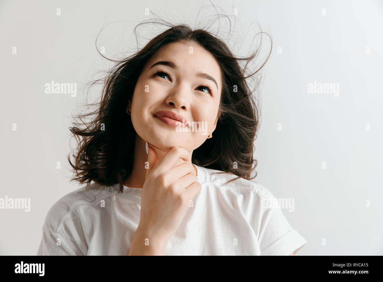 Remember all. Let me think. Doubt concept. Doubtful, thoughtful woman remembering something. Young asian emotional woman. Human emotions, facial expression concept. Studio. Stock Photo