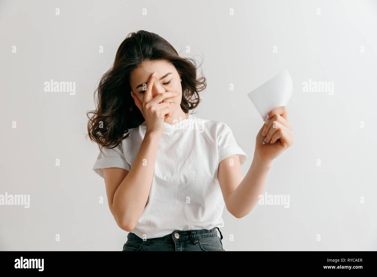 Young asian woman with a surprised unhappy expression lost a bet on studio  background. Human facial emotions and betting concept. Trendy colors Stock  Photo - Alamy