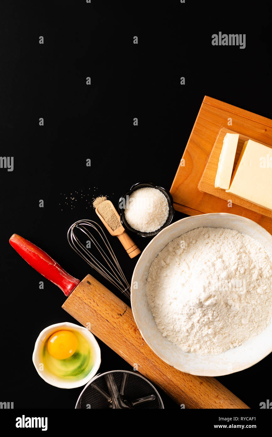 Food preparation concept over head shot kitchen tools for Kneading dough for bakery, pizza or pasta on black background with copy space Stock Photo