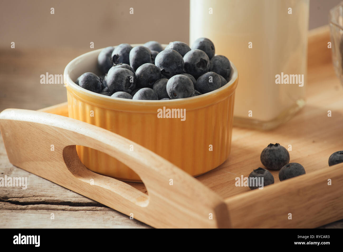 Healthy vegan breakfast. Bottled milk with chia, almond, fresh fruit and berries over wooden table background, copy space. Clean eating, weight loss,  Stock Photo