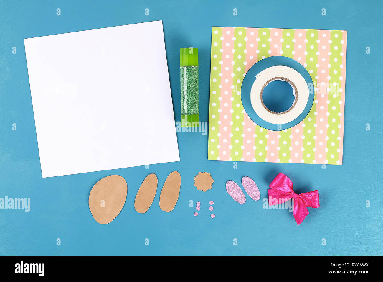 Diy Easter cards from paper. Volume greeting cards with a bunny, egg on blue background. 3d. Gift idea, decor Spring, Easter. Step by step. Top view. Stock Photo