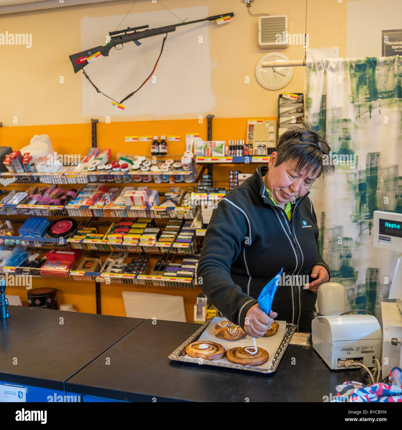 Woman working at a variety store, Qassiarsuk or Brattahlid, South Greenland Stock Photo
