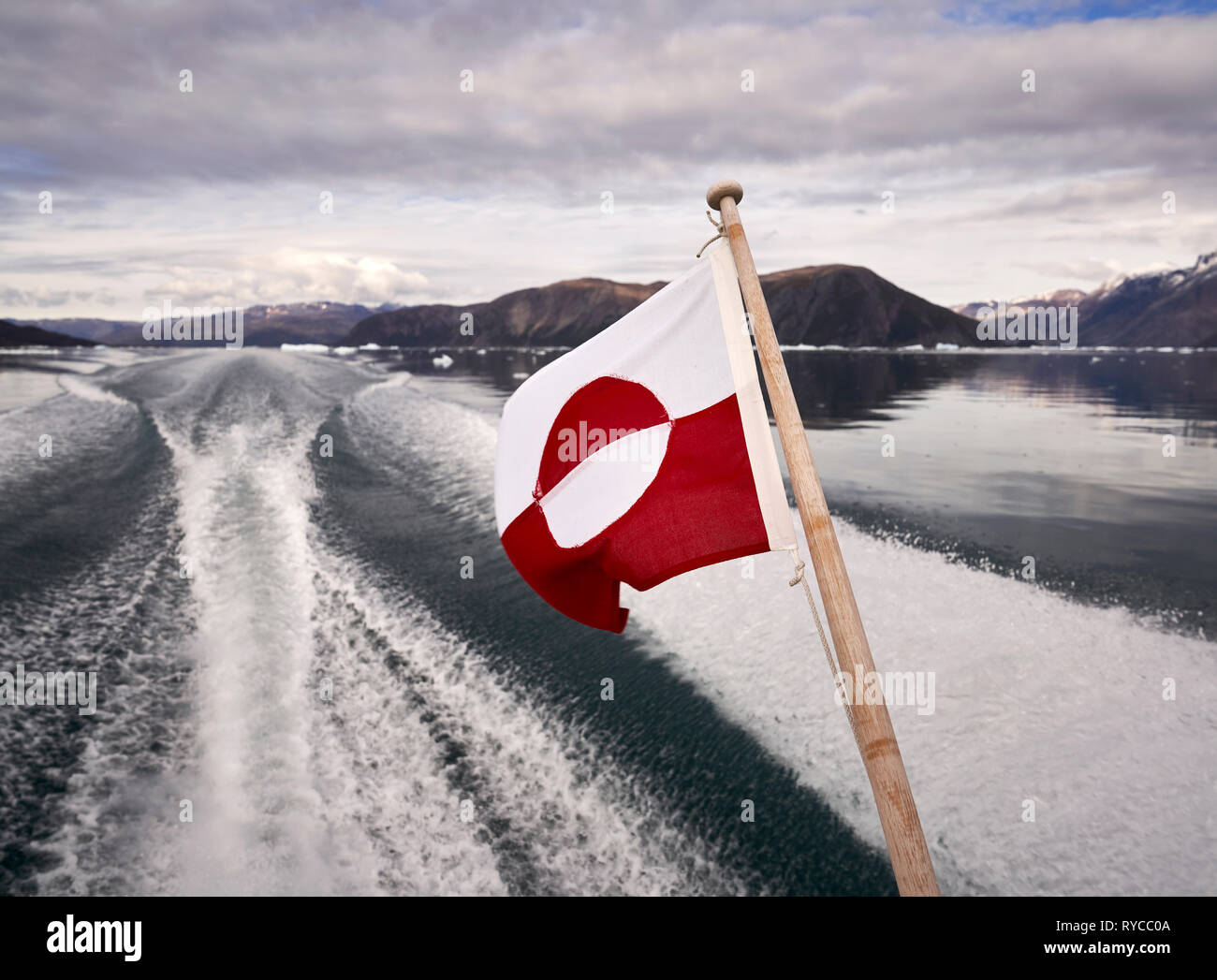 Greenlandic Flag, and wake on Eiriksfjordur, South Greenland Stock Photo
