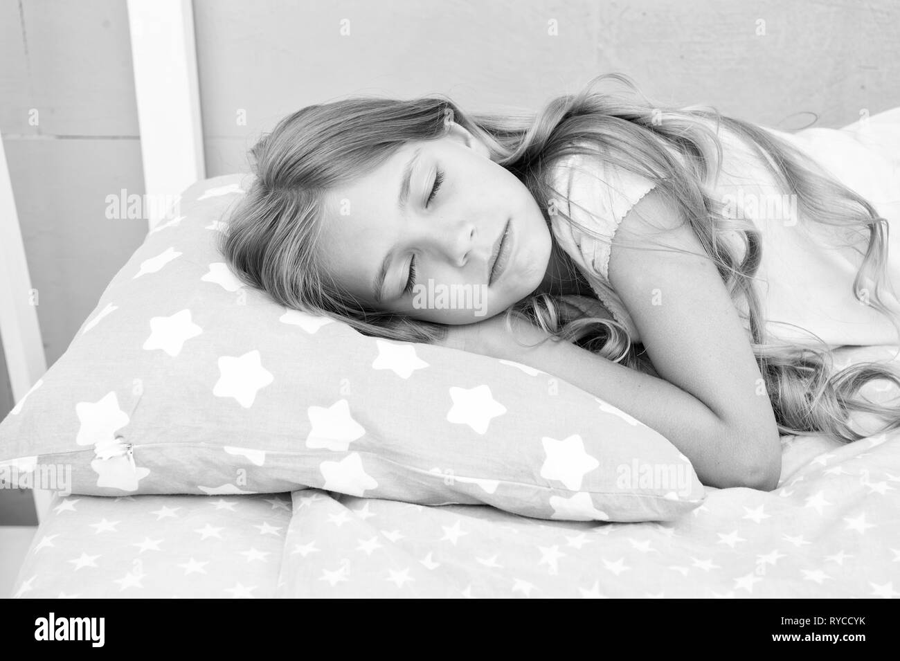 Healthy sleep tips. Girl sleep on little pillow bedclothes background