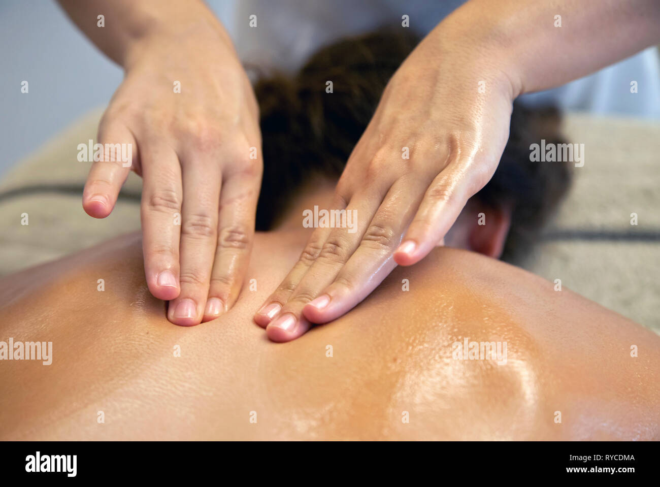 Close up on the hands of a masseuse during a massage treatment in a Spa in Ierapetra town, Crete, Greece. Stock Photo