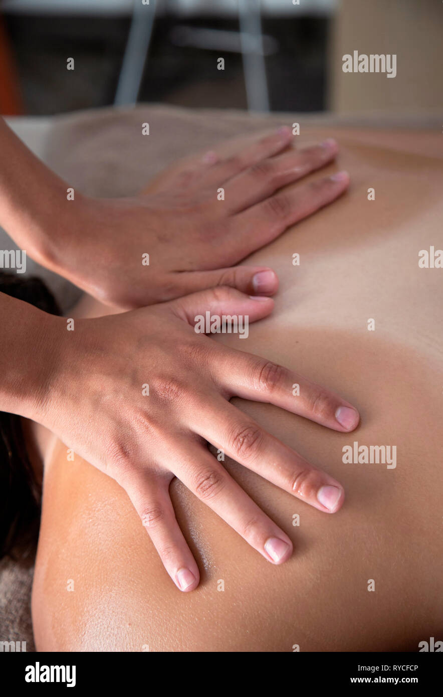 Close up on the hands of a masseuse during a massage treatment in a Spa in Ierapetra town, Crete, Greece. Stock Photo