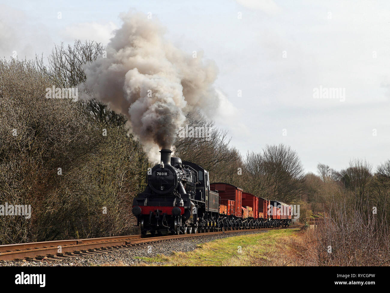 78018 heads past Little Burrs with a mixed freight on the East Lancs railway. Stock Photo