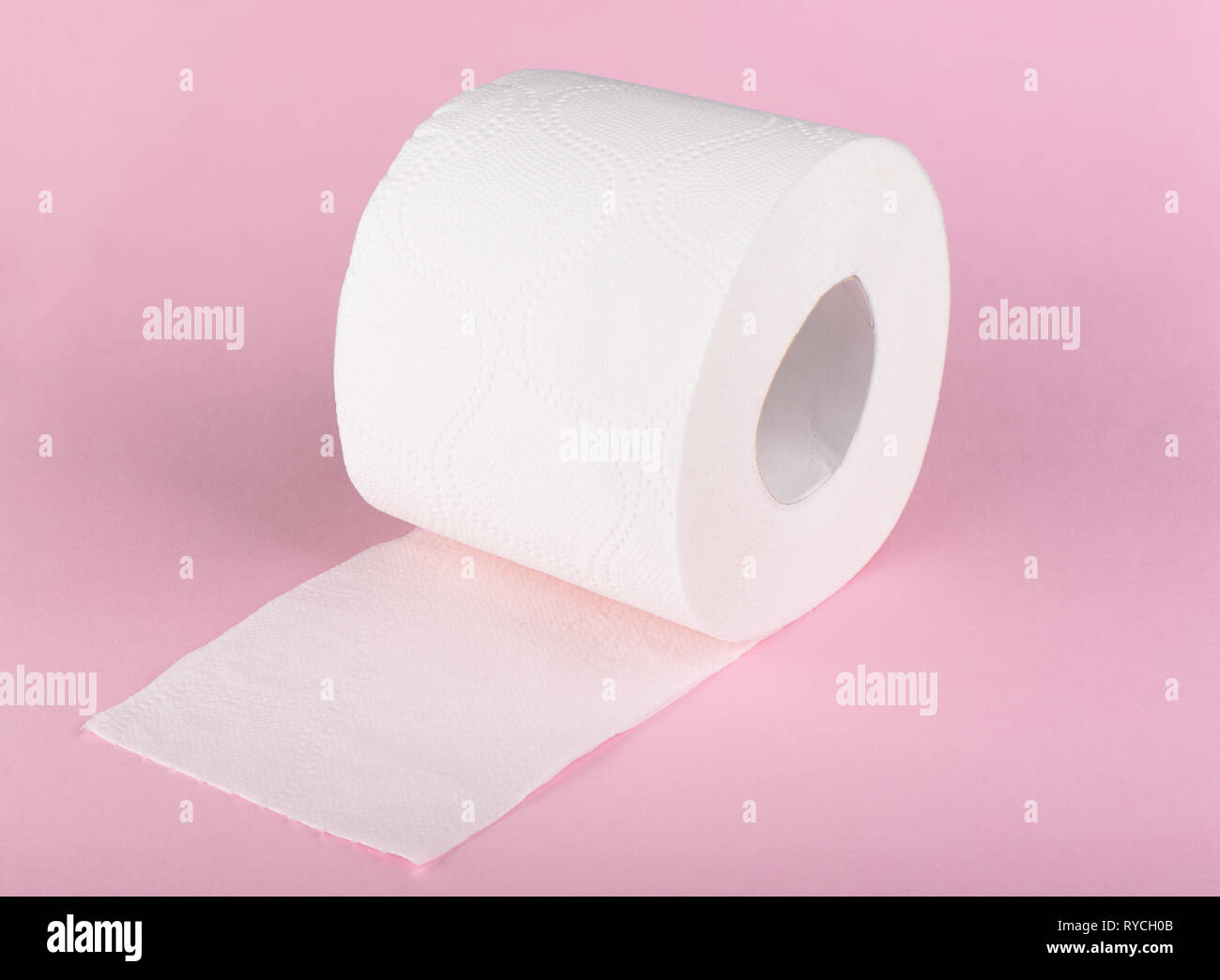 A roll of white toilet paper isolated on a pink background. The paper