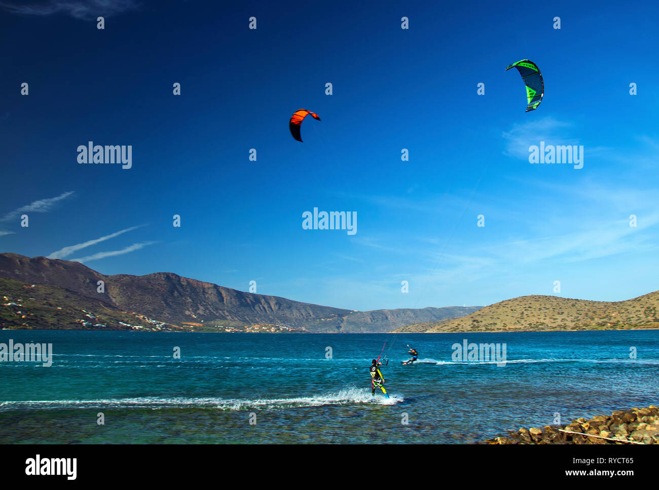 Kitesurfers at the bay of Mirabello, Elounda town, municipality of Agios Nikolaos, Lasithi, Crete. Stock Photo