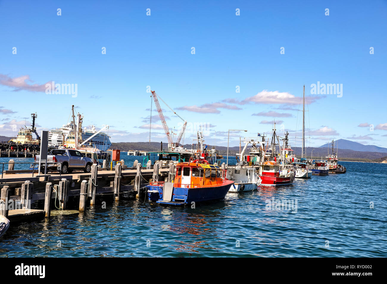 Fishing boats tied up at a wharf in Eden Harbour on Two Fold Bay on the southern coast of New South Wales Stock Photo