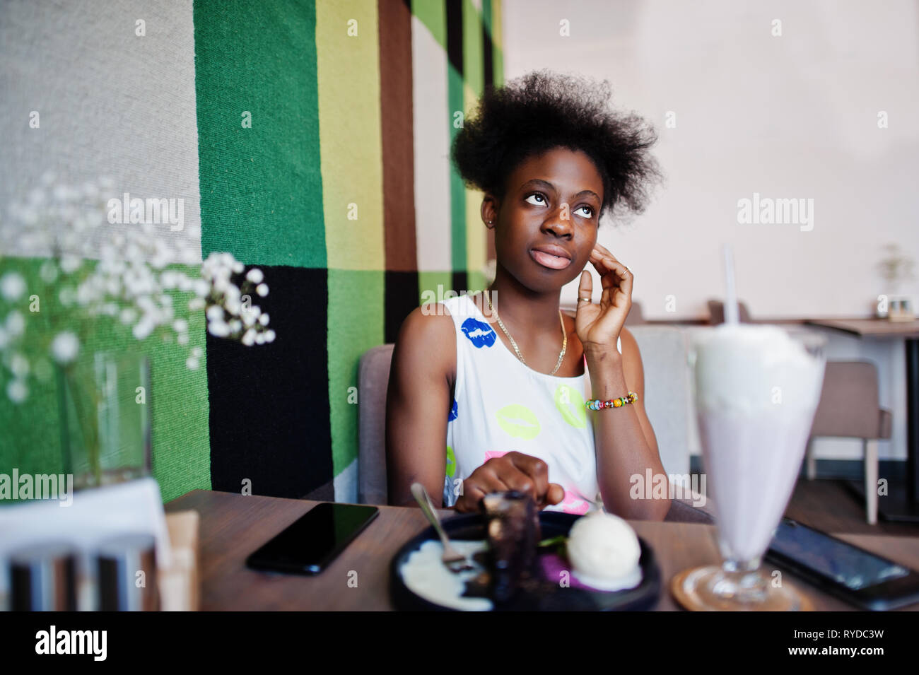 Сheerful african american young woman in summer dress and choker necklace  against black wooden background Stock Photo - Alamy