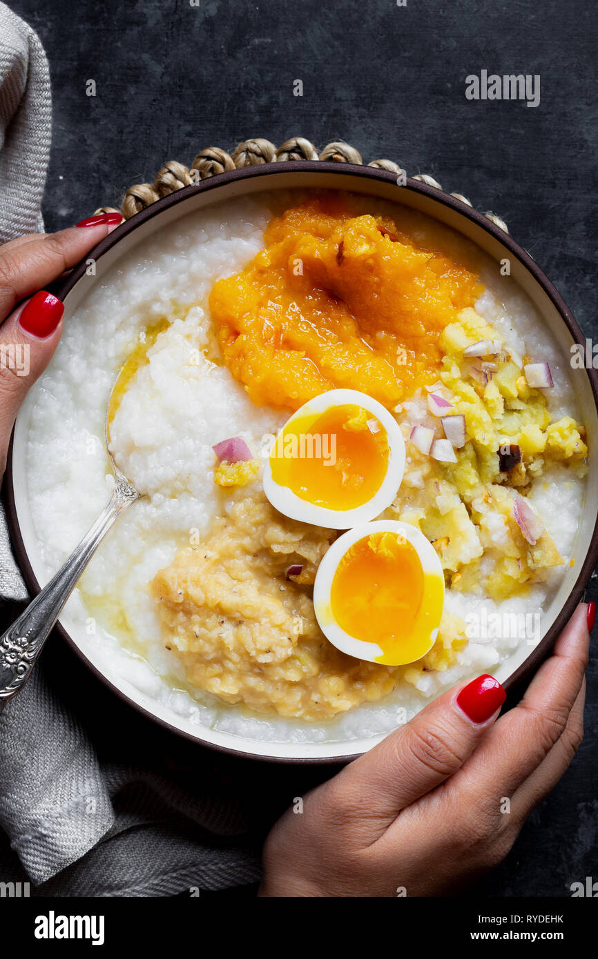 Indian comfort food - boiled rice, mashed pumpkin and potato, boiled lentil and 7-minutes egg. Stock Photo